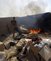 Man throwing trash into a burn pit