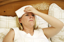Woman in bed sick with flu Woman in bed sick with flu