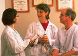 Two doctors talk with patient during examination Two doctors talk with patient during examination