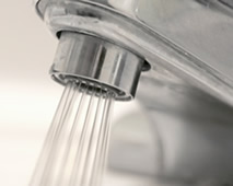 A faucet with water pouring from it A faucet with water pouring from it