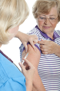Woman getting immunized Woman getting immunized