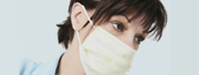 Employee Health: Closeup photo of a medical professional with a surgical mask over her face