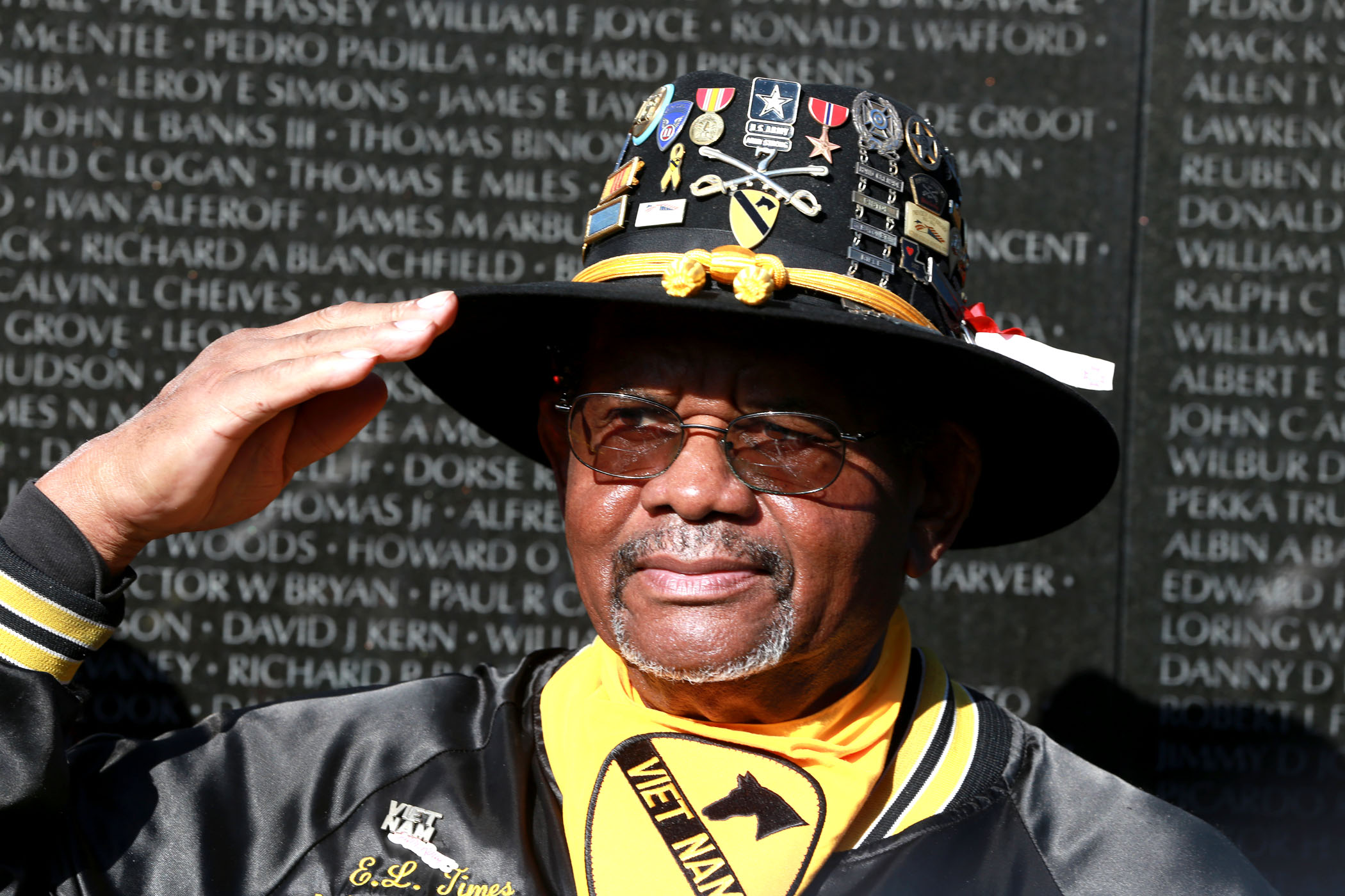 Veteran salutes in front of the Vietnam memorial in Washington D.C.