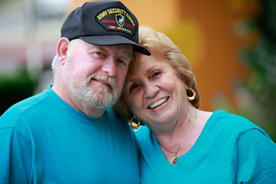 A Vietnam Veteran poses with his wife.