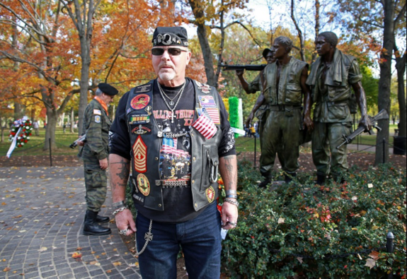 Vietnam Veteran standing in front of memorial on the National Mall for Veterans Day 2014