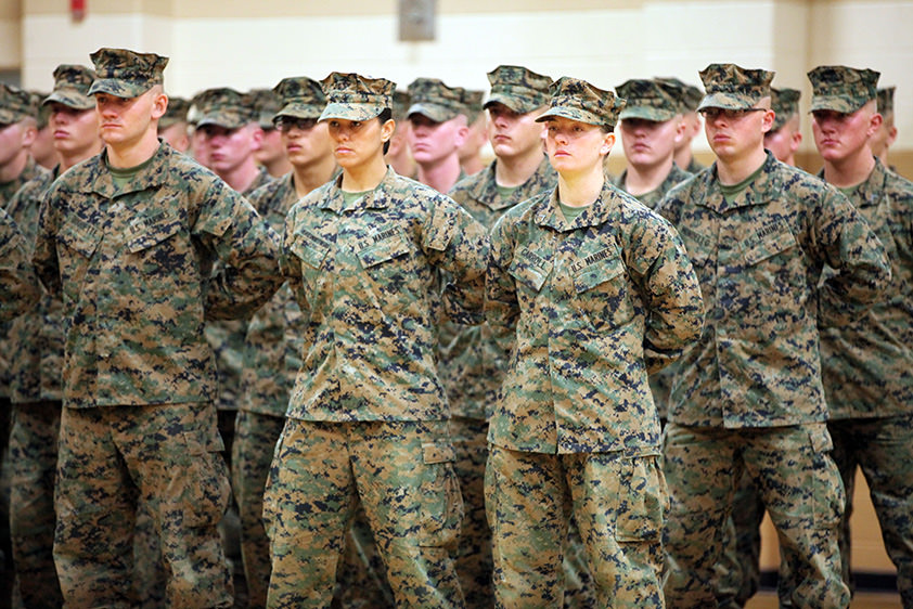 U.S. Marines stand at parade rest during a graduation ceremony.
