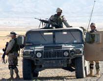 Three soldiers on patrol with jeep Three soldiers on patrol with jeep
