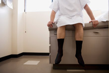 man sitting on exam table at doctor's office