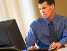 Man looking at data on a computer.