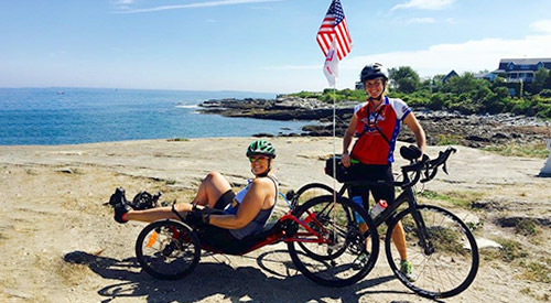 Recreation Therapy Month Two women bicycling along a path infront of a lighthouse