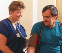 Medical professional  takes blood pressure of Veteran patient