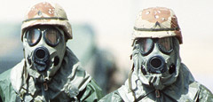 two soldiers wearing gas masks