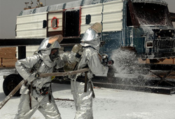 Fireman spraying Aqueous Film Forming Foam