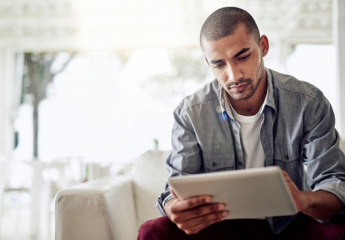 Male reviewing information on an iPad