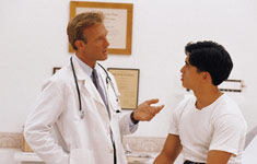 Doctor speaking with patient in examination room
