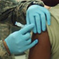 female servicemember getting vaccinated