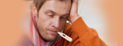 Closeup of a sick man with a thermometer in his mouth