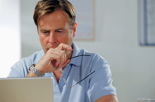 Man looking at data on a computer