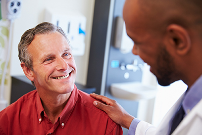 Male doctor greets a patient.