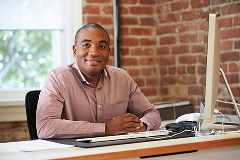 Man on a computer in his office