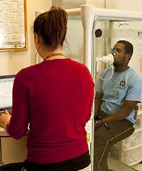 Researcher on a computer conducting a pulmonary test