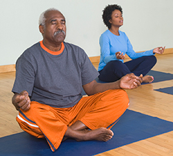 Two people in meditative yoga poses