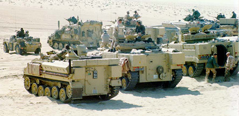 Military vehicles driving on sand