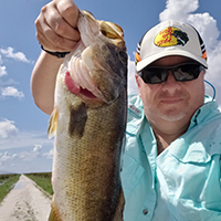 Watts holding a freshly caught basst