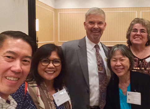 Dr. Erickson poses for a group photo at a care-coordinator conference