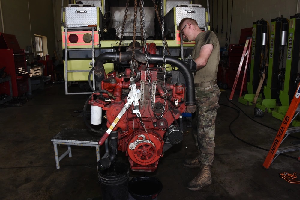  Army Sergeant works on diesel engine in the 185th Air Refueling Wing vehicle maintenance shop in Sioux City, Iowa
