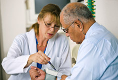 Female doctor talking   to male patient