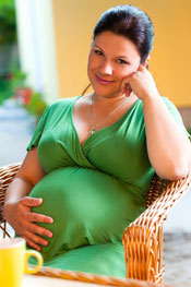 A pregnant woman sitting outside