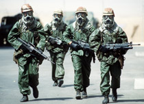 Four soldiers wearing gasmasks and protective gear Four soldiers wearing gasmasks and protective gear